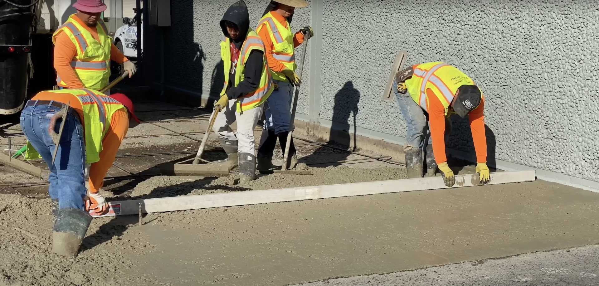 Experienced concrete contractors following proper installation procedures Professional concrete construction crew working on project