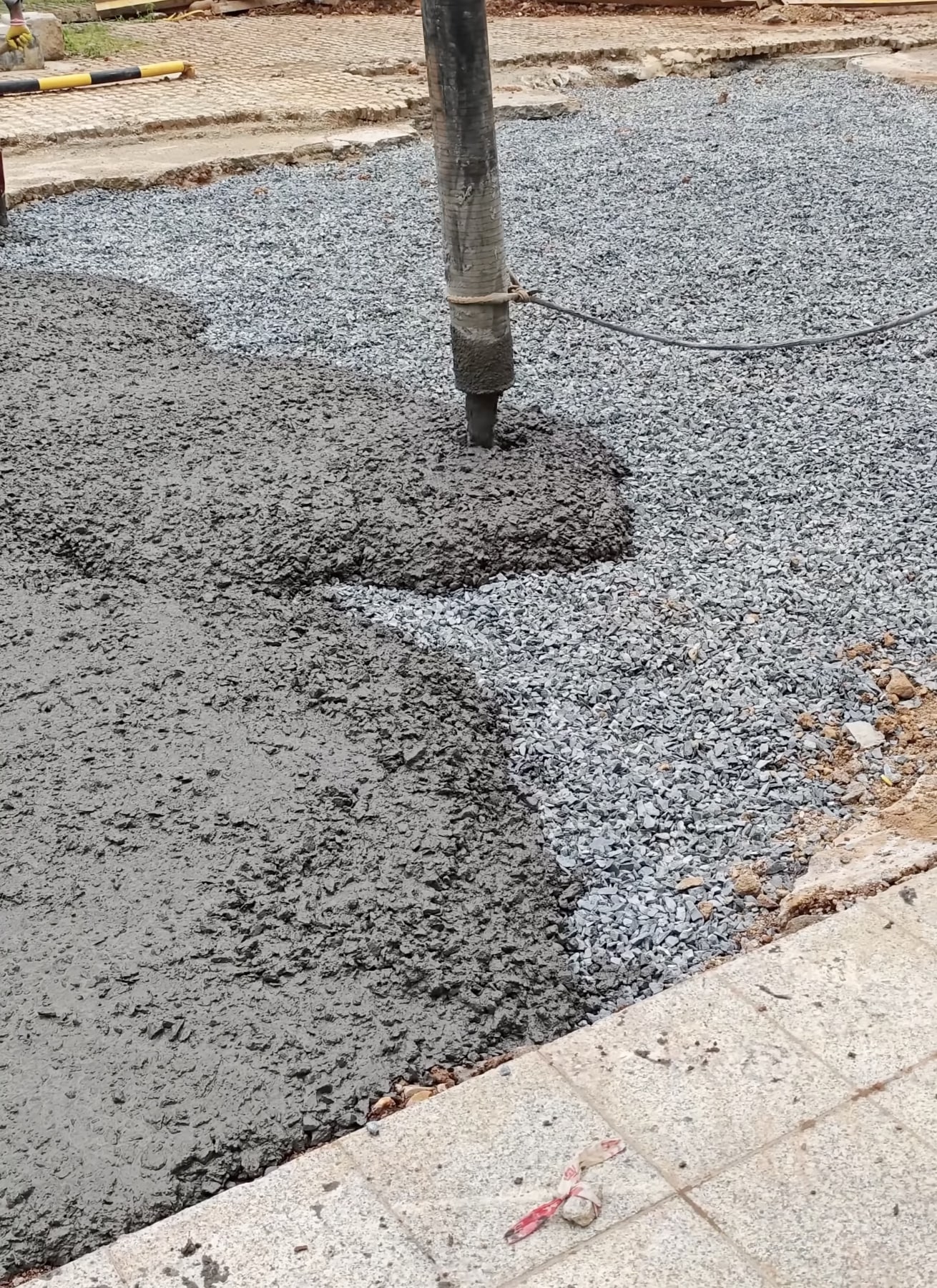 Professional concrete pouring using mechanical vibration tools Fresh concrete pour with professional vibrating equipment