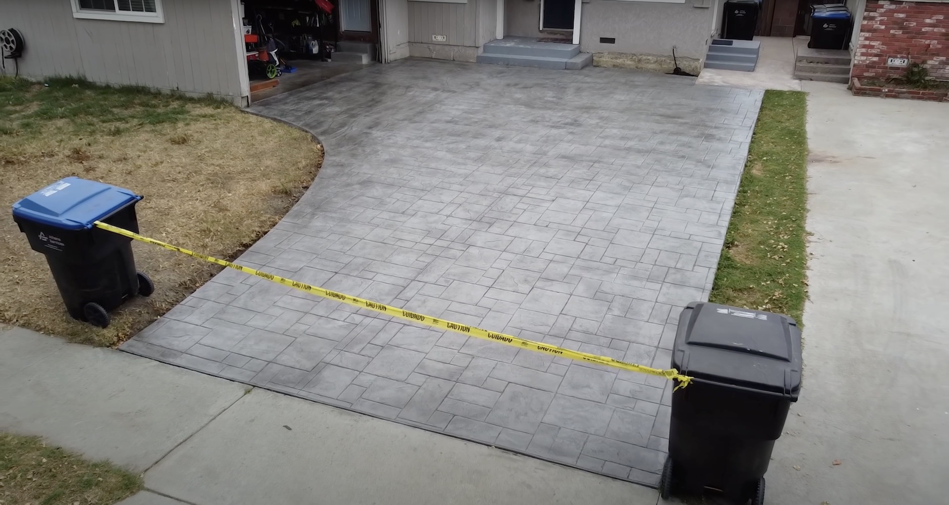 Professional stamped concrete driveway with brick texture pattern Stamped concrete driveway with decorative brick pattern