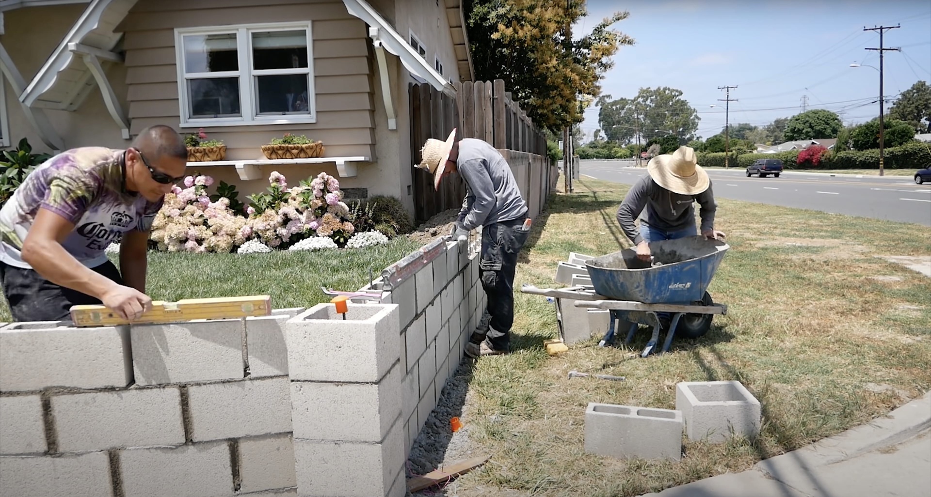 Professional concrete contractors building retaining wall Concrete block construction team working on residential project